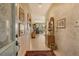 Bright entryway with tile flooring, featuring an ornate rug and gallery wall at 3416 W Chelmsford Ct # 2, Sarasota, FL 34235
