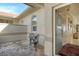 Covered entryway with glass door and small patio set at 3416 W Chelmsford Ct # 2, Sarasota, FL 34235