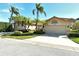 Tan two-car garage with decorative accents and landscaping at 3416 W Chelmsford Ct # 2, Sarasota, FL 34235