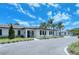 White building with dark windows, landscaping, and parking at 3416 W Chelmsford Ct # 2, Sarasota, FL 34235