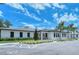 White building with dark windows, landscaping, and parking at 3416 W Chelmsford Ct # 2, Sarasota, FL 34235