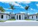 Modern white house with a sleek design and palm trees at 3416 W Chelmsford Ct # 2, Sarasota, FL 34235