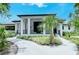 White building with a covered patio and lush landscaping at 3416 W Chelmsford Ct # 2, Sarasota, FL 34235