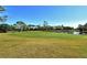 Expansive green golf course with a pond and mature trees at 3416 W Chelmsford Ct # 2, Sarasota, FL 34235