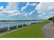Lakefront paved path with green grass at 3416 W Chelmsford Ct # 2, Sarasota, FL 34235