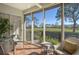Bright sunroom overlooking the golf course, featuring wicker furniture at 3416 W Chelmsford Ct # 2, Sarasota, FL 34235