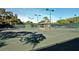 Well-maintained tennis court with a covered seating area at 3416 W Chelmsford Ct # 2, Sarasota, FL 34235