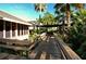 Wooden walkway through lush tropical landscaping at 3416 W Chelmsford Ct # 2, Sarasota, FL 34235