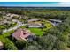 Aerial view of a luxury community with houses and a pond at 348 165Th Ne Ct, Bradenton, FL 34212