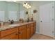 Bathroom with double vanity, granite countertop, and large mirror at 348 165Th Ne Ct, Bradenton, FL 34212