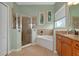 Bathroom boasts a large shower, soaking tub, and granite countertops at 348 165Th Ne Ct, Bradenton, FL 34212