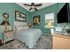 Guest bedroom with a queen bed, decorative artwork, and ceiling fan at 348 165Th Ne Ct, Bradenton, FL 34212