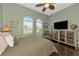 Spacious bedroom with two windows, a ceiling fan, and built-in shelving at 348 165Th Ne Ct, Bradenton, FL 34212