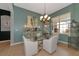 Elegant dining room with a glass table and chandelier at 348 165Th Ne Ct, Bradenton, FL 34212