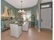 Bright dining room with glass table, chandelier, and mirrored buffet at 348 165Th Ne Ct, Bradenton, FL 34212