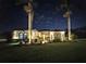 Single story home exterior view at night with landscape lighting at 348 165Th Ne Ct, Bradenton, FL 34212