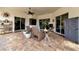 Relaxing covered patio with wicker seating, ceiling fans, and a view of the pool at 348 165Th Ne Ct, Bradenton, FL 34212