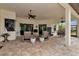 Relaxing covered patio with wicker seating, ceiling fans, and a view of the pool at 348 165Th Ne Ct, Bradenton, FL 34212
