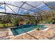 Lush landscaping surrounds this screened pool and spa at 348 165Th Ne Ct, Bradenton, FL 34212
