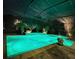 Stunning nighttime view of a backyard pool and spa at 348 165Th Ne Ct, Bradenton, FL 34212