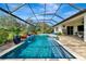 Inviting pool area with screened enclosure, waterfall feature, and spacious patio at 348 165Th Ne Ct, Bradenton, FL 34212