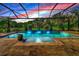 Relaxing screened pool and spa with water features at sunset at 348 165Th Ne Ct, Bradenton, FL 34212