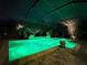 Backyard pool and spa with decorative lighting at night at 348 165Th Ne Ct, Bradenton, FL 34212