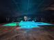 Backyard pool and spa with decorative lighting at night at 348 165Th Ne Ct, Bradenton, FL 34212