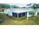Exterior view of home with screened-in patio and lush landscaping at 3522 Silver Pine Ct # 90, Sarasota, FL 34231