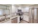 Modern kitchen with white cabinets, granite counters and stainless steel appliances at 3522 Silver Pine Ct # 90, Sarasota, FL 34231