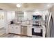 Updated kitchen with white cabinets, granite counters and stainless steel appliances at 3522 Silver Pine Ct # 90, Sarasota, FL 34231