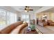 Living room with curved sofa and view of the back patio at 3522 Silver Pine Ct # 90, Sarasota, FL 34231