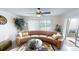 Relaxing living room with curved sectional sofa and tropical plants at 3522 Silver Pine Ct # 90, Sarasota, FL 34231