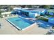 Community pool with surrounding patio furniture and lounge chairs at 3522 Silver Pine Ct # 90, Sarasota, FL 34231