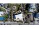 Modern home with flat roof, surrounded by lush landscaping and other houses at 3939 Higel Ave, Sarasota, FL 34242