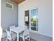 Private balcony with outdoor furniture and partial water view at 3939 Higel Ave, Sarasota, FL 34242