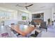 Long dining table with modern chairs, overlooking living room at 3939 Higel Ave, Sarasota, FL 34242
