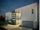 Modern three-story home with gray and white exterior, two-car garage, and palm trees at 3939 Higel Ave, Sarasota, FL 34242