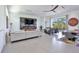 Spacious living area featuring a marble fireplace and large TV at 3939 Higel Ave, Sarasota, FL 34242