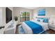 Main bedroom with wood flooring, large window and stylish bedding at 4001 Beneva Rd # 304, Sarasota, FL 34233