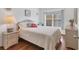 Bright bedroom with a comfortable queen-size bed and wood floors at 4110 Ironwood Cir # 301, Bradenton, FL 34209