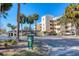 Three-story condo building with palm trees, parking and a sign; daytime photo at 4110 Ironwood Cir # 301, Bradenton, FL 34209