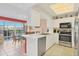 Modern kitchen with stainless steel appliances and a view to the dining area at 4110 Ironwood Cir # 301, Bradenton, FL 34209