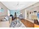 Spacious living room with hardwood floors, ceiling fan and coastal decor at 4110 Ironwood Cir # 301, Bradenton, FL 34209