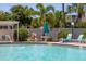 Relaxing pool area with lounge chairs and patio umbrella at 4110 Ironwood Cir # 301, Bradenton, FL 34209