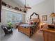 Large bedroom with wood bed frame and high ceilings at 4472 Via Del Villetti Dr, Venice, FL 34293