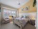 Bright bedroom with white bed frame and window seating at 4472 Via Del Villetti Dr, Venice, FL 34293
