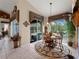 Casual breakfast nook with a round table and chairs, overlooking the pool at 4472 Via Del Villetti Dr, Venice, FL 34293