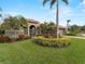 Landscaped lawn, palm trees, and a two-car garage at 4472 Via Del Villetti Dr, Venice, FL 34293