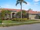 Single-story home with tile roof, palm trees, and landscaped yard at 4472 Via Del Villetti Dr, Venice, FL 34293